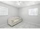 Bedroom with a white sofa, marble floors, a ceiling fan, and a bright window at 4507 9Th W St # J11, Bradenton, FL 34207