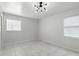 Bright bedroom with modern lighting, marble floors, and large windows at 4507 9Th W St # J11, Bradenton, FL 34207