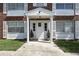 Apartment entrance featuring a white door and columns with white shutters and potted plants at 4507 9Th W St # J11, Bradenton, FL 34207