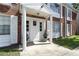 Apartment entrance featuring a white door and columns with white shutters and potted plants at 4507 9Th W St # J11, Bradenton, FL 34207