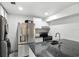Modern kitchen with stainless steel appliances, granite countertops, and white cabinets at 4507 9Th W St # J11, Bradenton, FL 34207