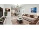 Bright living room with marble floors, a modern chandelier, and contemporary furnishings at 4507 9Th W St # J11, Bradenton, FL 34207