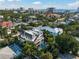 Aerial view of the modern home featuring palm trees, rooftop deck, and private pool at 455 Cleveland Dr, Sarasota, FL 34236