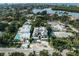 Aerial view of the modern home in its tropical neighborhood, complete with a pool and lavish landscaping at 455 Cleveland Dr, Sarasota, FL 34236