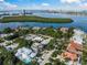 Aerial view of a modern home surrounded by lush landscaping and waterfront neighborhood views at 455 Cleveland Dr, Sarasota, FL 34236