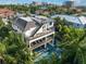 Aerial view of a modern home with multiple balconies, an outdoor spa, and a pool at 455 Cleveland Dr, Sarasota, FL 34236
