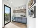 Entertainment space with bar area and glass door to balcony at 455 Cleveland Dr, Sarasota, FL 34236
