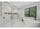 Luxurious bathroom featuring a glass-enclosed shower, soaking tub, and marble accents at 455 Cleveland Dr, Sarasota, FL 34236