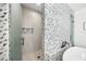 Elegant bathroom boasting a glass walk-in shower with triangular mosaic wall at 455 Cleveland Dr, Sarasota, FL 34236