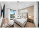 Bedroom boasts a private balcony, wood floors, and serene decor at 455 Cleveland Dr, Sarasota, FL 34236