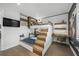 A stylish bedroom featuring a custom-built bunk bed with integrated desk and storage, plus hardwood floors and TV at 455 Cleveland Dr, Sarasota, FL 34236