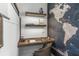 A modern desk area featuring floating shelves, a world map, and a sleek chair at 455 Cleveland Dr, Sarasota, FL 34236