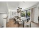 Dining room with modern light fixture, balcony access, and room for eight chairs at 455 Cleveland Dr, Sarasota, FL 34236
