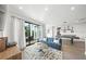 Open concept game room with balcony access and a chic blue sofa at 455 Cleveland Dr, Sarasota, FL 34236