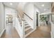 Bright hallway with hardwood floors, modern staircase, and views into the dining area at 455 Cleveland Dr, Sarasota, FL 34236
