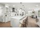 Bright open kitchen featuring a large island with seating and views into the dining area at 455 Cleveland Dr, Sarasota, FL 34236