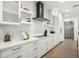 Modern kitchen showcasing white cabinets, countertops, and a black range hood at 455 Cleveland Dr, Sarasota, FL 34236