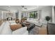 Well-lit living room featuring large windows and sliding doors, offering scenic views and access to outdoors at 455 Cleveland Dr, Sarasota, FL 34236