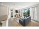 Bright living room features balcony access, wood floors, and contemporary design at 455 Cleveland Dr, Sarasota, FL 34236
