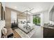 Bright and airy main bedroom with a canopy bed, wood floors, and sliding glass doors to a balcony at 455 Cleveland Dr, Sarasota, FL 34236