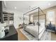 Inviting bedroom with a four-poster bed, natural light, and neutral decor at 455 Cleveland Dr, Sarasota, FL 34236