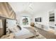 Bright main bedroom with large windows, vaulted ceiling, and stylish furnishings at 455 Cleveland Dr, Sarasota, FL 34236