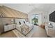 Spacious main bedroom with accent wall, vaulted ceiling, and private balcony access at 455 Cleveland Dr, Sarasota, FL 34236