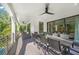 An outdoor dining area featuring a large table, seating, tropical foliage, and a fan for cooling at 455 Cleveland Dr, Sarasota, FL 34236