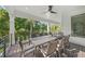 An outdoor dining area featuring a large table, seating, and lush tropical views at 455 Cleveland Dr, Sarasota, FL 34236