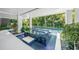 Outdoor lounge with a raised spa and tropical landscaping near the backyard pool at 455 Cleveland Dr, Sarasota, FL 34236