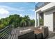 An outdoor patio featuring wicker furniture and scenic views of tropical greenery and blue skies at 455 Cleveland Dr, Sarasota, FL 34236
