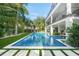 Backyard pool with turf and palm trees surrounding the exterior of the modern home at 455 Cleveland Dr, Sarasota, FL 34236