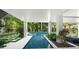Open, covered luxury pool area with beautiful landscaping and accents at 455 Cleveland Dr, Sarasota, FL 34236