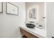 Stylish powder room featuring a unique stone sink, modern fixtures, and elegant decor at 455 Cleveland Dr, Sarasota, FL 34236