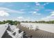 An expansive roof deck featuring Adirondack chairs and leafy tree views at 455 Cleveland Dr, Sarasota, FL 34236