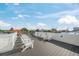 An expansive roof deck featuring Adirondack chairs and city views at 455 Cleveland Dr, Sarasota, FL 34236