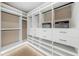 Spacious walk-in closet with custom shelving, drawers, and ample storage space with bright, modern lighting at 455 Cleveland Dr, Sarasota, FL 34236