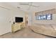 Comfortable bedroom with neutral decor, a built in desk, tiled floors, and a window for natural light at 495 Oak Hill Cir # 44, Sarasota, FL 34232