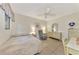 Cozy bedroom featuring tiled floors, ceiling fan, sitting chair, and a well-lit dresser with mirror at 495 Oak Hill Cir # 44, Sarasota, FL 34232