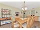Charming dining room with a wooden table, seating for six, and open access to kitchen at 495 Oak Hill Cir # 44, Sarasota, FL 34232