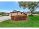 Charming home featuring a well-manicured lawn, vibrant landscaping, and inviting curb appeal at 495 Oak Hill Cir # 44, Sarasota, FL 34232