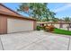 The front exterior features a wide driveway leading to an attached two-car garage, and a well-maintained lawn at 495 Oak Hill Cir # 44, Sarasota, FL 34232