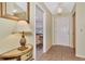 Welcoming foyer with tiled flooring, decorative mirror, and view into the dining room at 495 Oak Hill Cir # 44, Sarasota, FL 34232