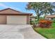 Attached two car garage and wide driveway on home with well-manicured landscaping at 495 Oak Hill Cir # 44, Sarasota, FL 34232