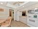 Bright kitchen with white cabinets, a microwave, and an adjacent breakfast table at 495 Oak Hill Cir # 44, Sarasota, FL 34232