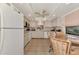 Bright kitchen with white cabinets, tile floors, and eat-in dining area at 495 Oak Hill Cir # 44, Sarasota, FL 34232