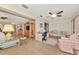 Open-concept living room with tile floors, ceiling fan, built-in shelves, and comfortable seating at 495 Oak Hill Cir # 44, Sarasota, FL 34232