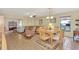 Inviting living room with a large sectional sofa, wooden dining table, and tiled floors at 495 Oak Hill Cir # 44, Sarasota, FL 34232
