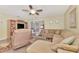 Comfortable living room with plush seating, a ceiling fan, and view to the sunroom at 495 Oak Hill Cir # 44, Sarasota, FL 34232