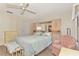 Bedroom with a large bed, built-in storage cabinets, and a pink accent chair at 495 Oak Hill Cir # 44, Sarasota, FL 34232